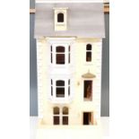 A three storey dolls house with attic with hinged door and lift up roof, wired for battery powered