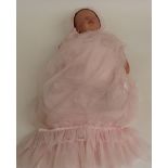 Laura Tuzio-Ross Reborn silicone doll with closed mouth and eyes and brown hair, marked to the