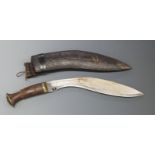 Kukri knife with 27cm curved blade, in leather sheath.