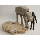 Three Star Wars action figures and vehicles comprising Darth Vader Millennium Falcon and AT-AT