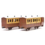 A pair of 32mm gauge garden railway passenger coaches in brown and cream livery, one with guard's