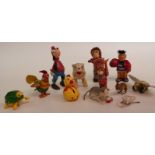 Eleven clockwork tinplate and plastic toys, including Disney Goofy, monkey, cats etc.