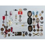 WWII German quantity of reproduction insignia, medals etc