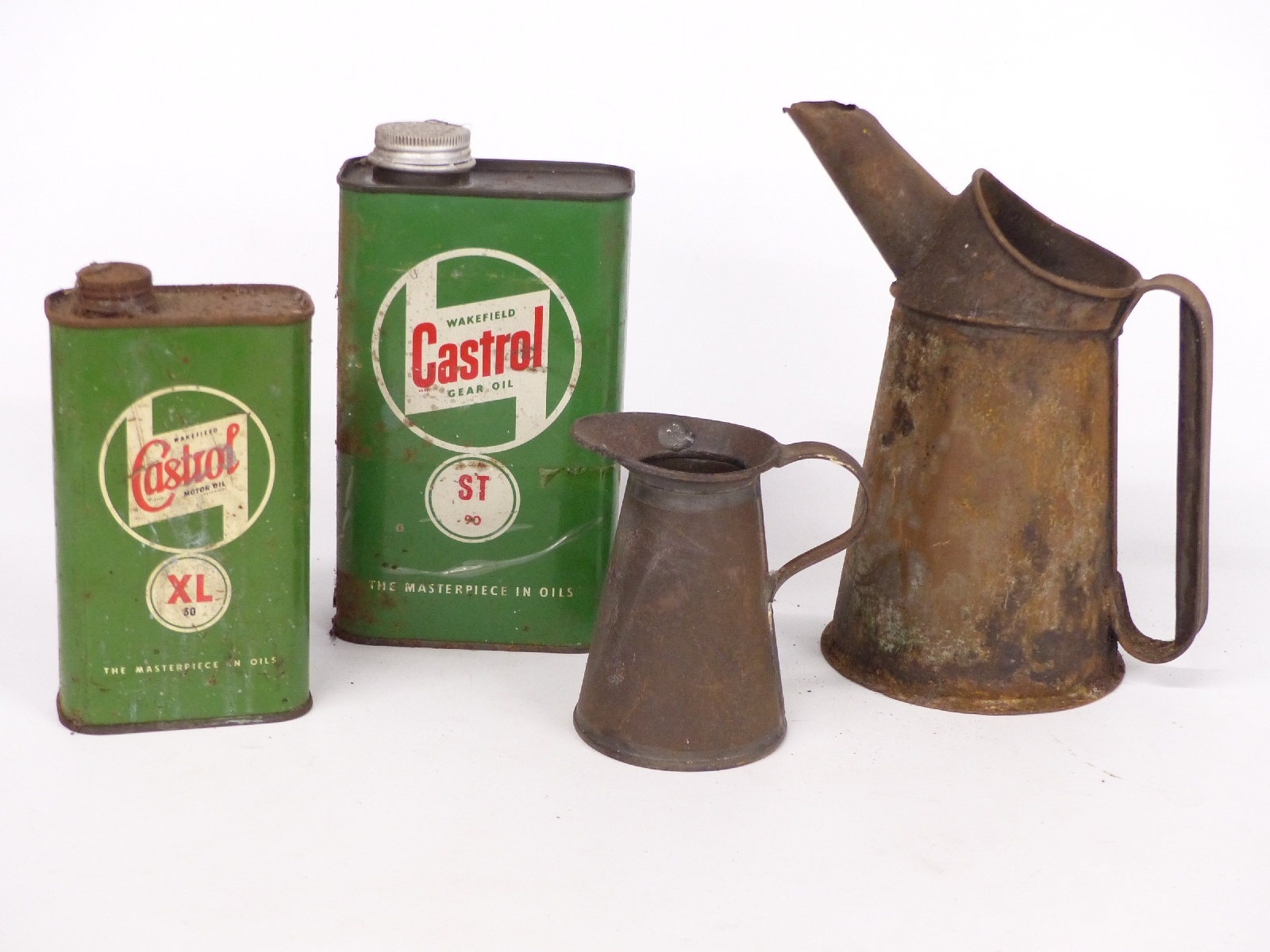 Two vintage garage oil cans and two Castrol oil cans, one XL motor oil the other ST 90 gear oil