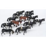 Thirteen Britains and similar diecast model horses with military saddles, each 6.5cm tall
