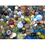 A large collection of glass marbles including clear and multi-coloured examples.
