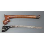 A Polynesian / Kris style dagger with 22cm blade, in carved wooden scabbard.