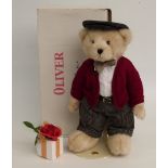 The Danbury Mint Teddy bear Oliver with blonde mohair, tartan trousers, red cardigan and flat cap,