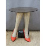 Retro / kitsch glass topped table supported by two ladies' stockinged legs in red high heels with
