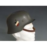 WWII German steel helmet with two decals, leather liner and chin strap