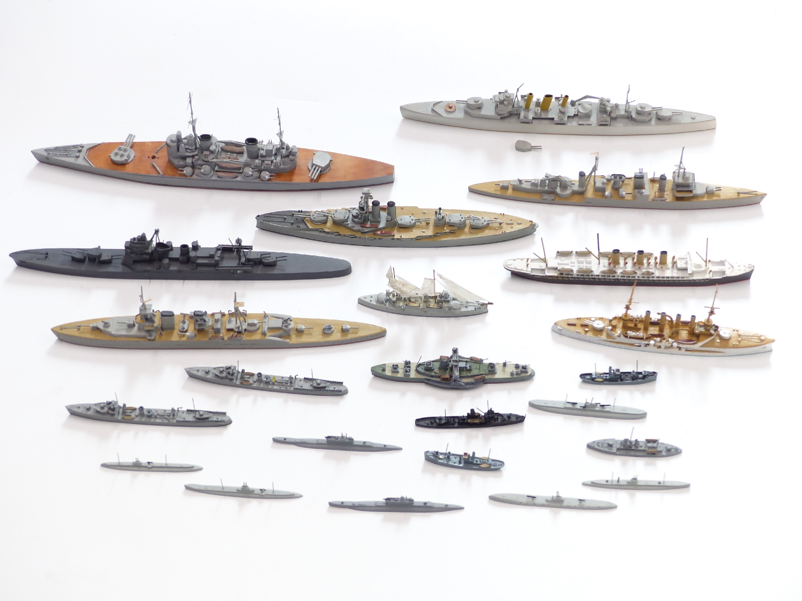 Twenty-two Neptun and similar diecast and wooden model waterline ships including Roon, Enterprise,