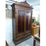 19th century continental carved oak cabinet with carved mask and fruit decoration to pediment,