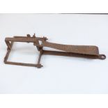 A 19thC man / bear trap of iron construction with single spring loaded mechanism, originally from