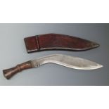 Kukri knife with 31cm curved blade, in leather sheath stamped 1945.