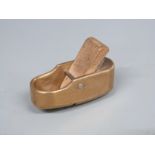 Small brass or bronze finger plane with double curved face, length 5cm
