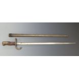 French 1874 Model T bayonet with 52cm blade and stamped 97087 to the quillion, in metal scabbard.