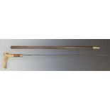 A 19thC sword stick with yellow metal mounts and deer horn handle and 71cm fullered blade.