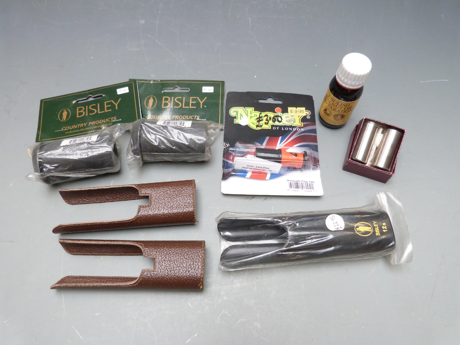 A collection of gun accessories and cleaning kit including snapcaps, forend covers, auto-safe flag