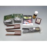 A collection of gun accessories and cleaning kit including snapcaps, forend covers, auto-safe flag