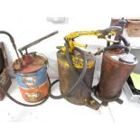 Two vintage oil dispensers, one marked Regent Oil Co Ltd and a Fina grease dispenser