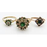 A 9ct gold ring set with a diamond and emerald and two 9ct gold rings with faux emeralds, 5.5g