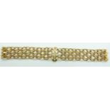 An 18ct gold oval link bracelet set with four old cut diamonds in star settings, 43.8g