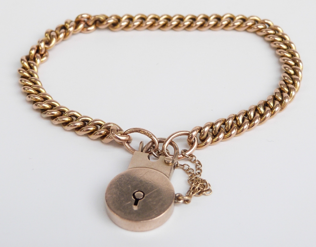 A 9ct gold curb link bracelet with a padlock clasp 10.4g