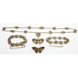 A suite of Japanese jewellery comprising butterfly brooch and pendant and two bracelets