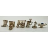 Six silver charms including a steam engine, sun dial, lamps,  etc