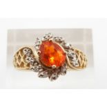 A 14ct gold ring set with an oval cut fire opal and diamonds, 4.1g, size T