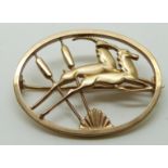 Geoffrey Bellamy for Ivan Tarratt 9ct gold brooch in the form of jumping gazelle and bulrushes