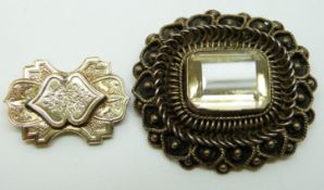 Victorian brooch set with an emerald cut citrine and a yellow metal brooch