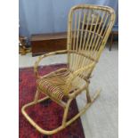 A cane/wicker rocking chair