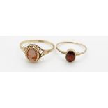 A 9ct gold ring set with an oval cut garnet and a 9ct gold ring set with a cameo, 2.4g