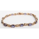 A 9ct gold bracelet set with oval cut tanzanites, 5.5g