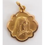 An 18ct gold pendant with relief decoration of the Virgin Mary, 1.8g