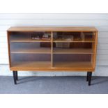 Gordon Russell of Broadway bookcase with sliding glass doors, W138 x D30 x H95cm