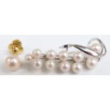 A naturalistic pearl brooch marked silver, length 50mm and a pearl tie pin