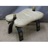 An upholstered carved camel stool, W40 x D57cm