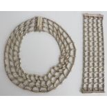 A white metal necklace and matching bracelet made up of cylinder links in a net pattern, 282g