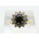 An 18ct gold ring set with a round cut tourmaline surrounded by diamonds, 3.7g, size O
