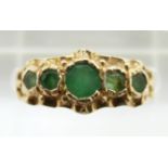 A 9ct gold ring set with emeralds, 2.1g, size M