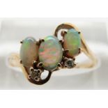 A 14ct gold ring set with opals and two diamonds, 2.3g, size O