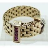 Art Deco buckle ring made up of rectangular links set with four square step cut rubies and five