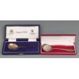 Two cased hallmarked silver spoons, one a Mappin & Webb seal top example with rose to top, weight