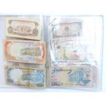 An album containing Asian and Indo China banknotes together with a reproduction Indo China -