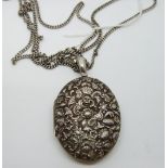 Victorian white metal locket with embossed floral and foliate design on a white metal fob/guard