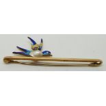 A 15ct gold brooch in the form of a bird/ swallow set with a pearl to the body and enamel, in
