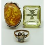 Two silver rings, one set with pressed amber and the other citrine and another silver gilt ring