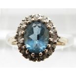A 9ct gold ring set with an aquamarine surrounded by diamonds, 2.9g, size M